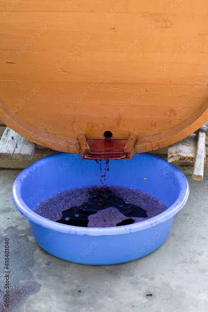 Grape juice close up during the autumn harvest. Traditional old technique of wine making. Filtering grape must. Grape juice close up during the autumn harvest. Traditional old technique of wine making. Filtering grape must.