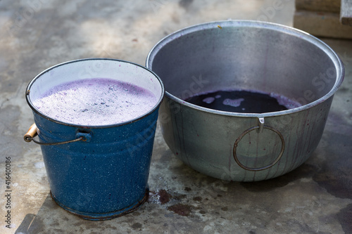 Grape juice close up during the autumn harvest. Traditional old technique of wine making. Filtering grape must.