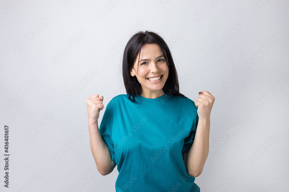 Close up portrait of attractive shouting in winning smiling with raised fists young she her girl wearing jeans shirt clothes isolated on grey background Close up portrait of attractive shouting in winning smiling with raised fists young she her girl wearing jeans shirt clothes isolated on grey background