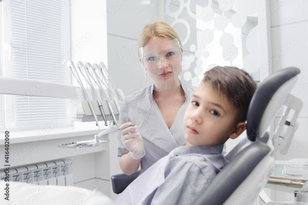 A child boy with a dentist in a dental office A child boy with a dentist in a dental office