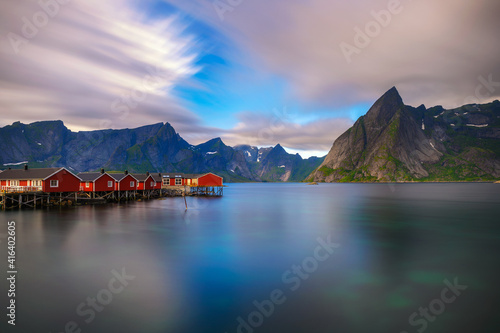 Sunset above mount Olstind and red fishing cabins in Lofoten Islands, Norway © Nick Fox