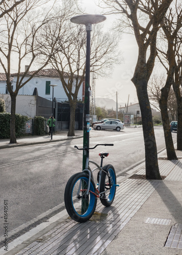 Super-wide tires bicycle on urban street. Sunset. Sport.