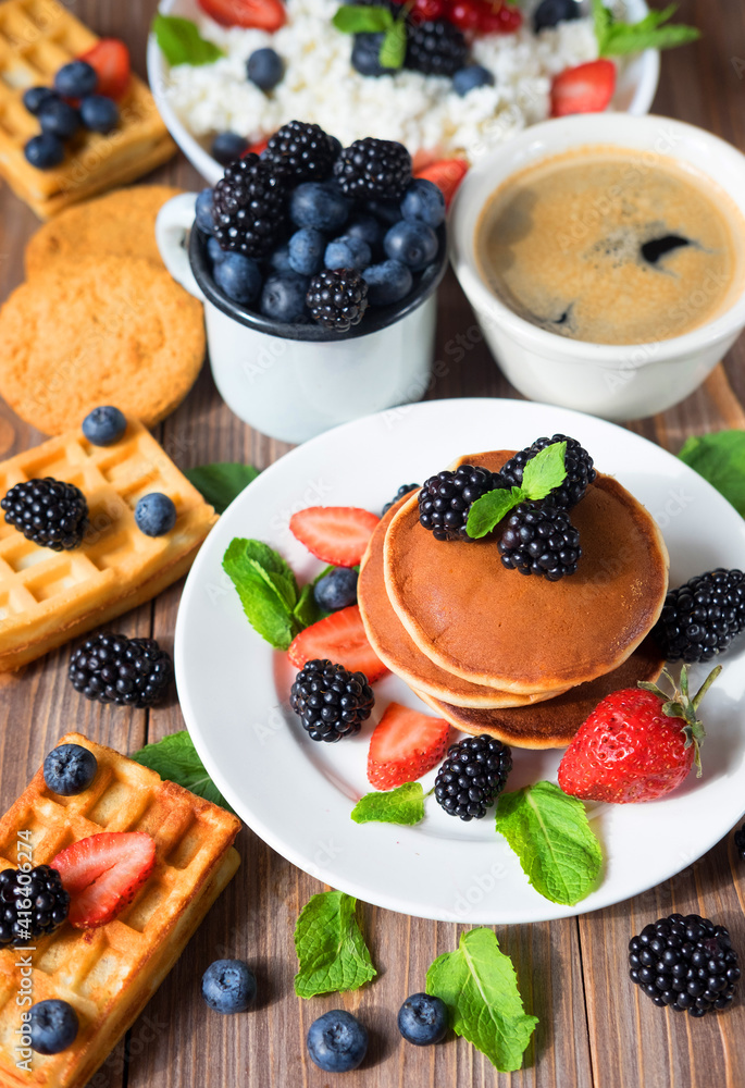 Pancakes with blackberries, raspberries and straberries. American cuisine. Coffee and waffles. Dessert. Recipes Breakfast Pancakes with blackberries, raspberries and straberries. American cuisine. Coffee and waffles. Dessert. Recipes Breakfast