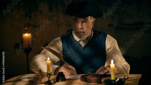Foto An 18th century scene of a mature man in a tricorn or cocked hat writing a lette