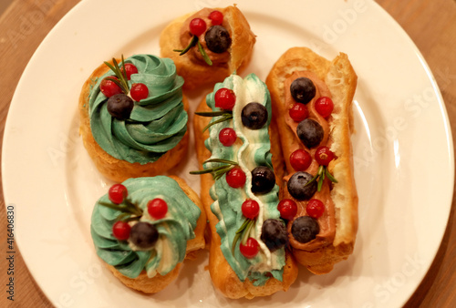 Juicy and bright eclairs with the taste of berries  caramel and strawberries