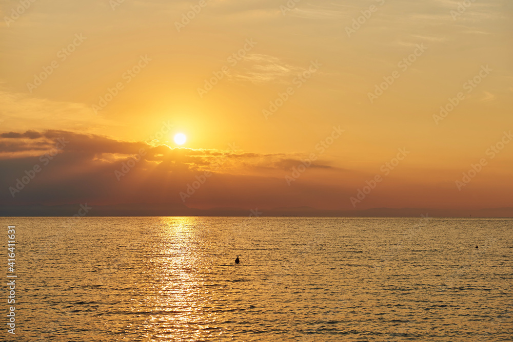 Amazing Sunset on the Sea. Adriatic sea, beautiful sunset, waves and landscape.  Lignano Sabbiadoro, Italy.
