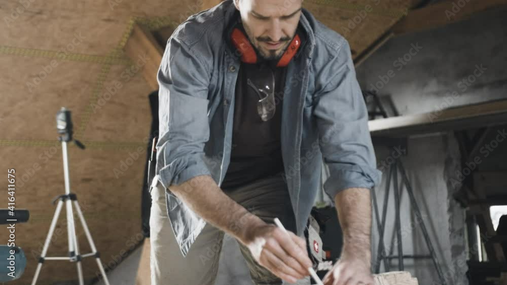 Worker sketching on wood Worker sketching on wood