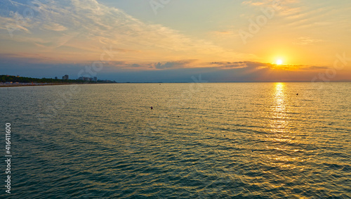Amazing Sunset on the Sea. Adriatic sea, beautiful sunset, waves and landscape. Lignano Sabbiadoro, Italy.