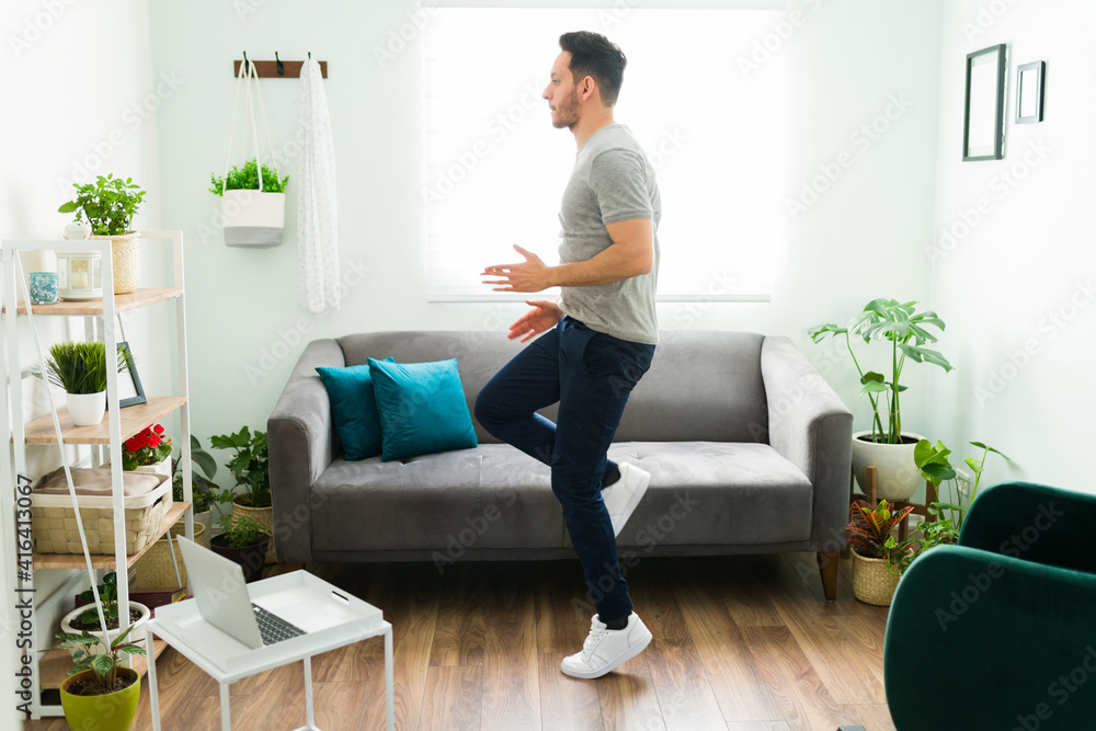 Healthy man training with a cardio routine at home Healthy man training with a cardio routine at home