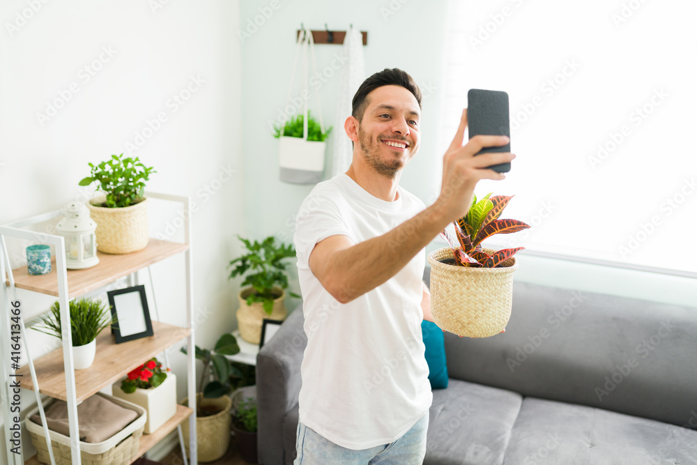 Happy man showing online his gardening hobby to friends Happy man showing online his gardening hobby to friends