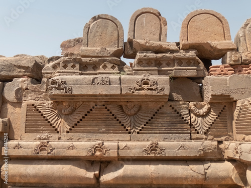 carved stone decorations on a wall at chand baori, a stepwell in the indian state of rajasthan photo