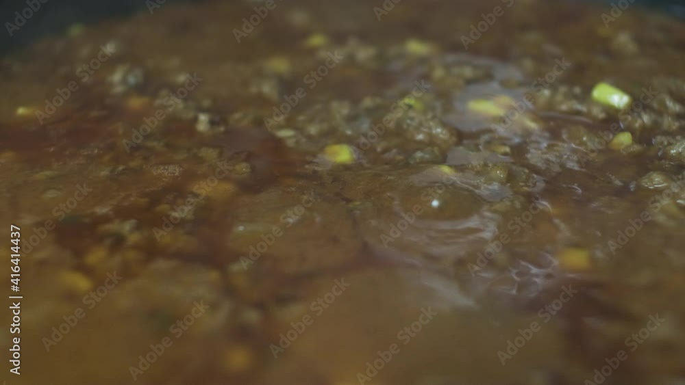 Simmering Mince Meat With Sweet Corn. Close Up, Low Angle, Locked Off Simmering Mince Meat With Sweet Corn. Close Up, Low Angle, Locked Off