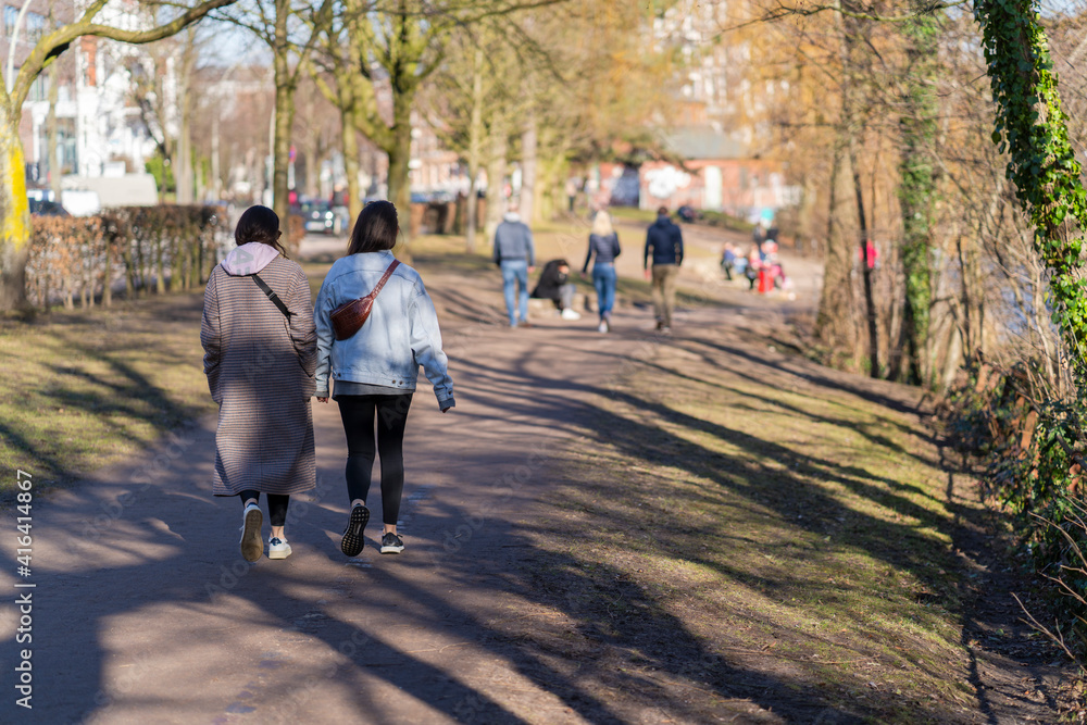 two friends go for a spring walk in the park