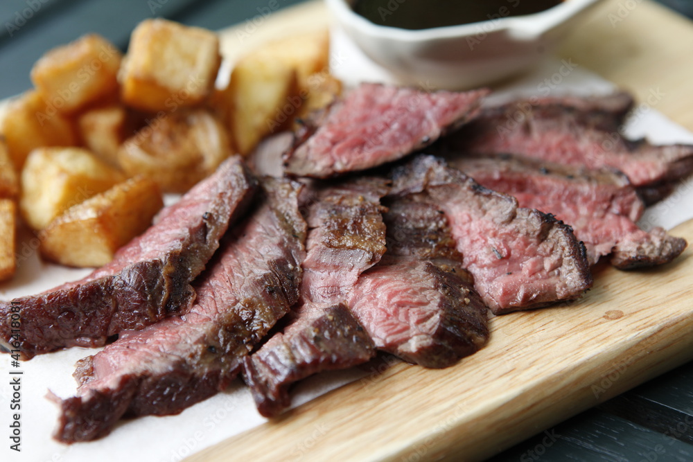 raw beef steak on wood plate