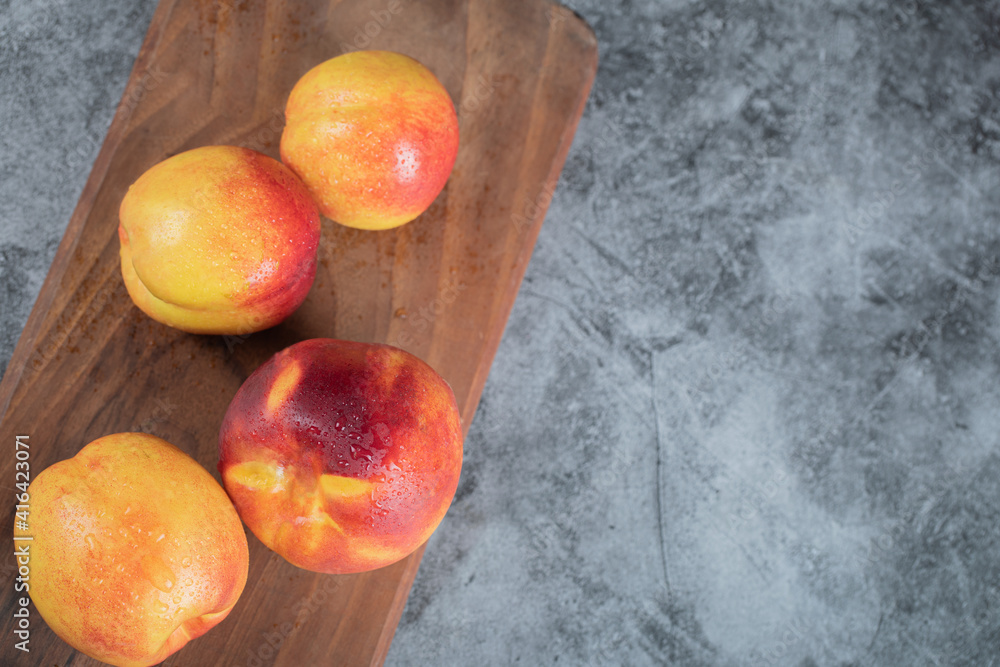 Yellow red peaches on a wooden board Yellow red peaches on a wooden board