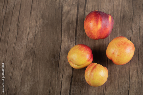 Yellow red peaches on a wooden deck