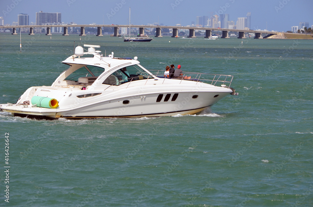 White motor yacht cruising on the Florida Intra-Coastal Waterway.