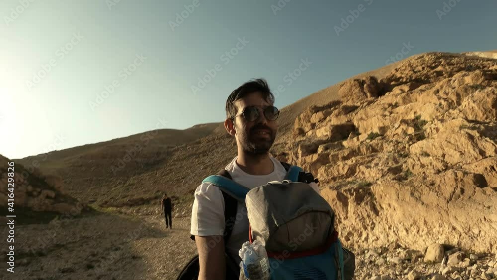 Young traveller busy talking with camera on top of Mountain - Concept of travel vlogger, blogger or influencer recording video during hiking. High quality 4k footage Young traveller busy talking with camera on top of Mountain - Concept of travel vlogger, blogger or influencer recording video during hiking. High quality 4k footage