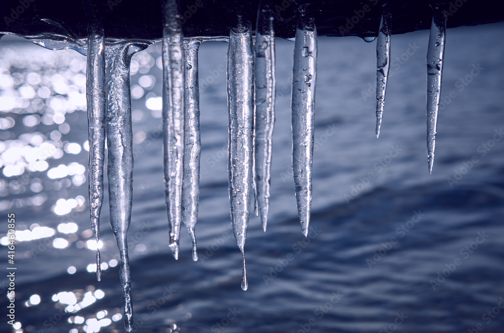 Icicles hanging over the water Icicles hanging over the water