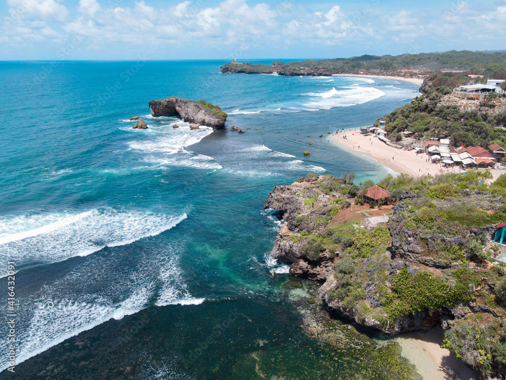 Fototapeta premium Aerial view of Beautiful beach in Gunung Kidul, Indonesia in daylight.
