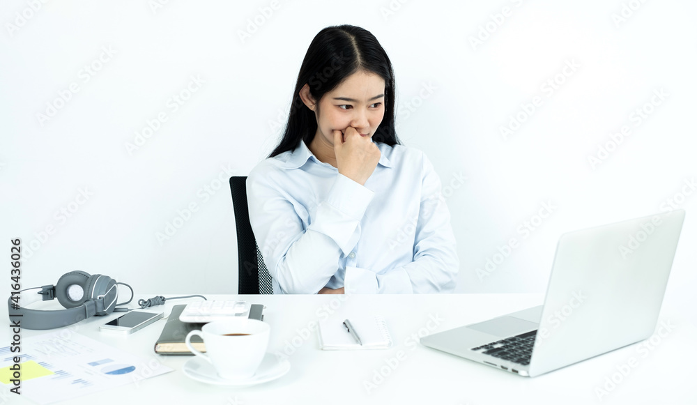 Working Asian women feel stressed, dismal tired from work, migraine headaches from hard work while working at the office Working Asian women feel stressed, dismal tired from work, migraine headaches from hard work while working at the office