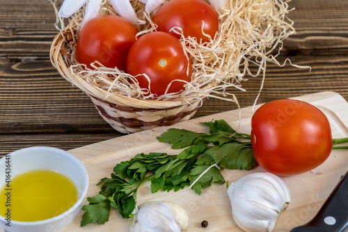 Tomatoes on the table and in the basket, olive oil and balsamic vinegar, garlic, vegetables, vegetarianism, healthy eating