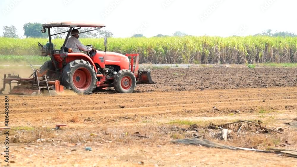 Farmer drive the Tractor Plow the soil for prepair sapling the vegetable Farmer drive the Tractor Plow the soil for prepair sapling the vegetable