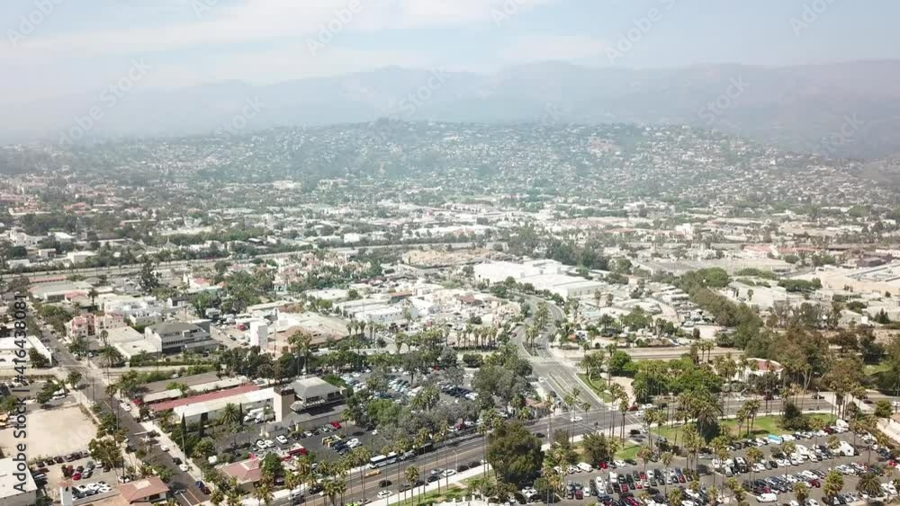 Aerial dolly backwards looking at the town of Santa Barbara with shopping, palm trees and car parks Aerial dolly backwards looking at the town of Santa Barbara with shopping, palm trees and car parks
