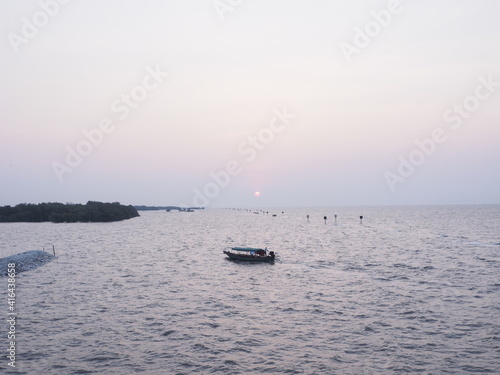 The morning sun rises where tourists are popular to come to visit the sea temple and see the local fishermen lifestyle next to the sea