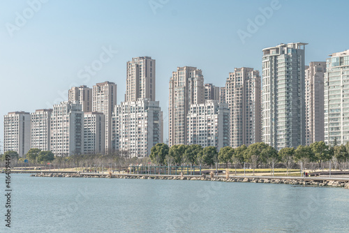 Modern residential skyscrapers in Suzhou, along a lake. © Zimu