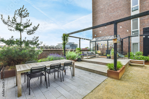 A large open-air terrace on the roof-top with lounge space photo