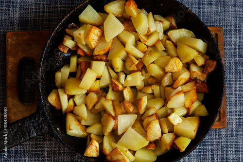 Pan fried potatoes on a wooden cutting board.