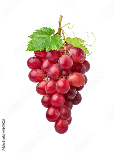 Red grape cluster with green leaves isolated on white background.