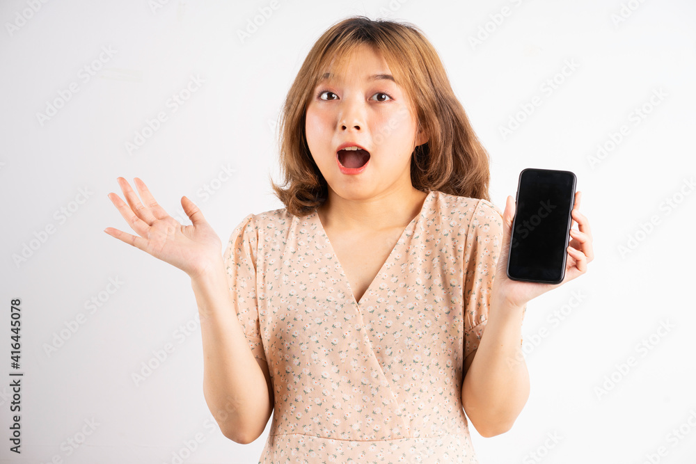 Young asian girl holding phone with expressions, gestures on background Young asian girl holding phone with expressions, gestures on background