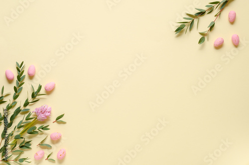 Pink eggs, hyacinth and eucalyptus on yellow background