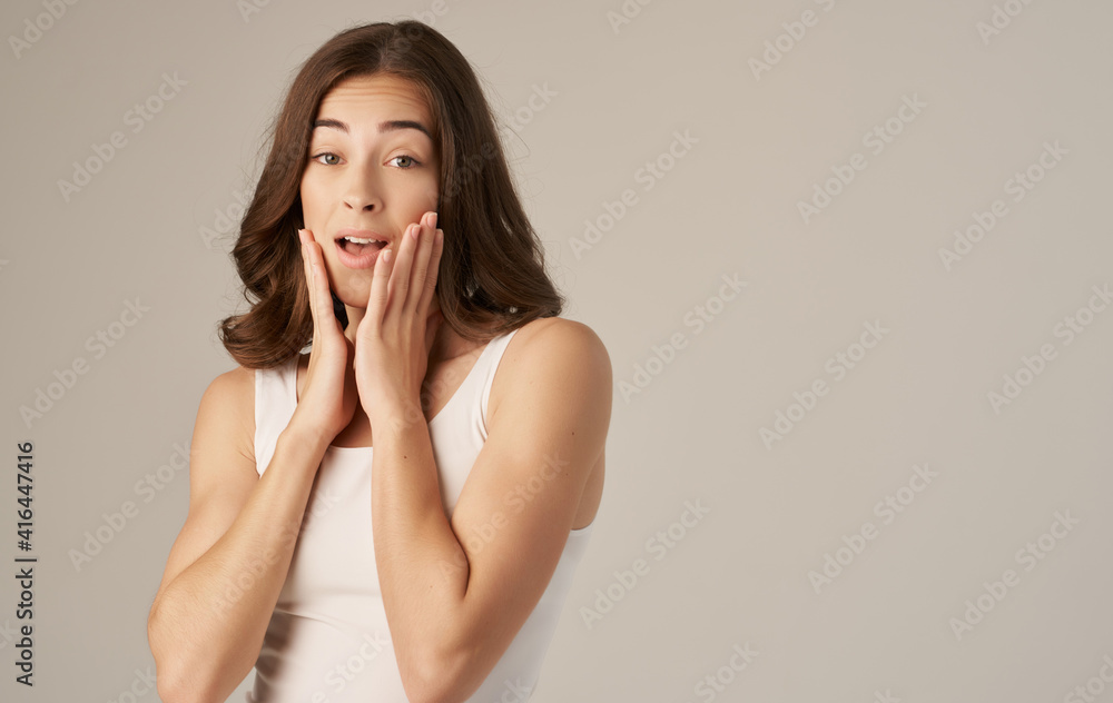 pretty brunette in white t-shirt smile emotions beige background pretty brunette in white t-shirt smile emotions beige background