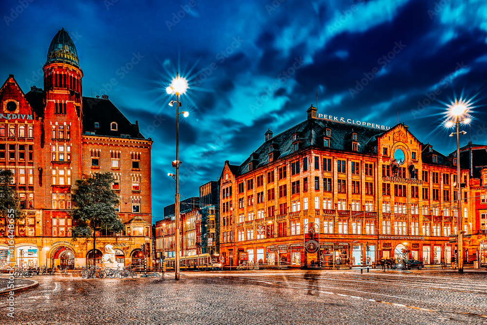 AMSTERDAM, NETHERLANDS - SEPTEMBER 15, 2015: Beautiful Amsterdam, centre of  Dam Square in the evening. Square is a central place for local inhabitants and tourists of the Dutch capital.