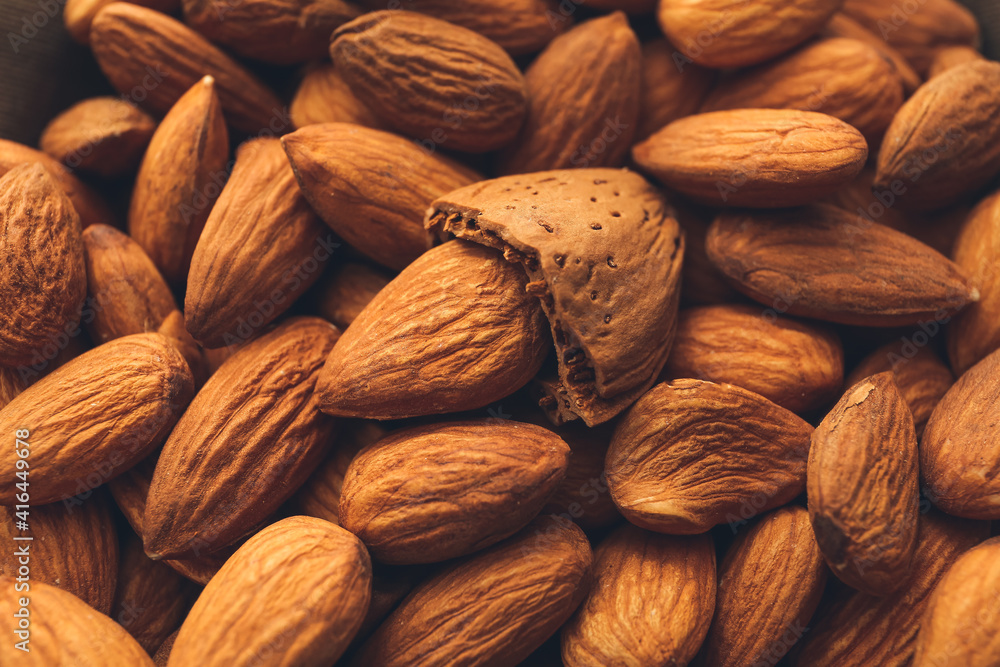 Fototapeta premium Heap of tasty almonds as background