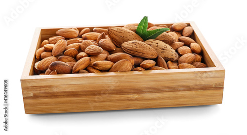 Wooden box with healthy almonds on white background © Pixel-Shot