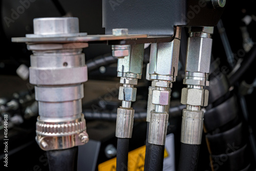 Close up of high-pressure pipe connector on dark background photo