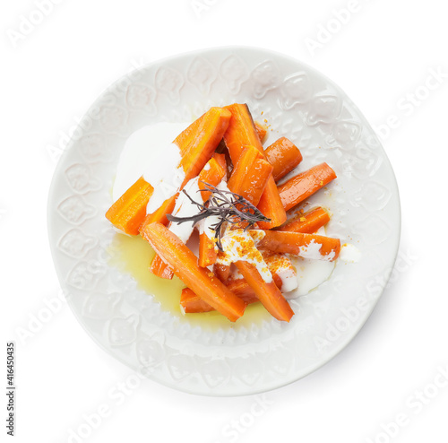 Plate of tasty baked carrot on white background