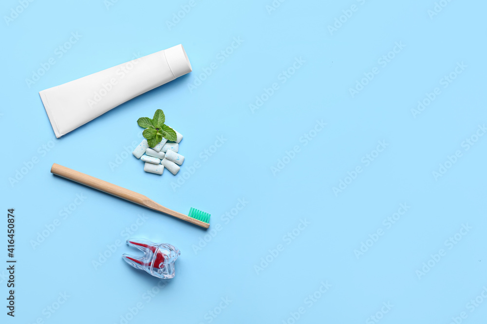 Chewing gums, toothbrush and paste on color background Chewing gums, toothbrush and paste on color background