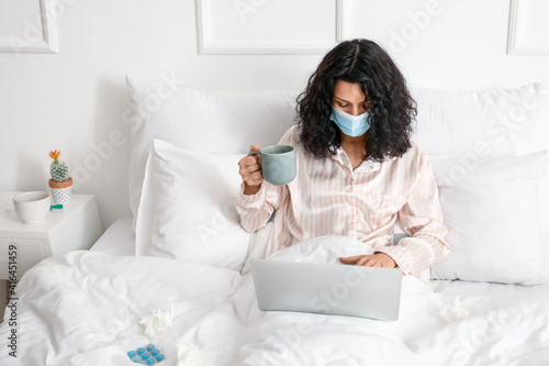 Sick young woman with lapto...