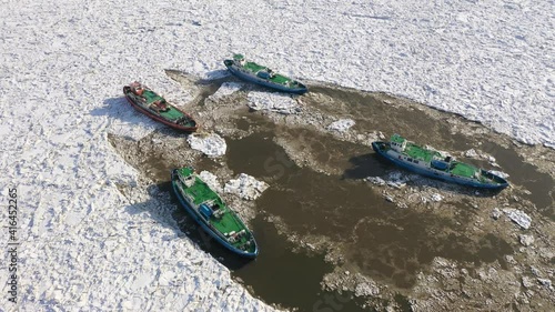 Icebreaker ships crushing ice on Vistula river, Plock, 2021,  Poland photo