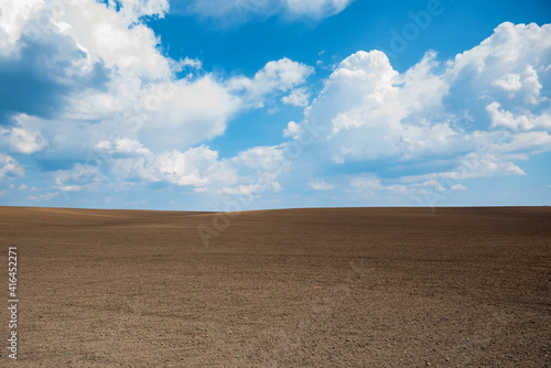 Canvas Print Empty brown soil of field and blue sky for natural background