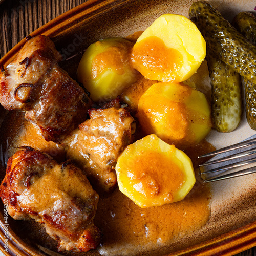 Rustic Snirtjebraten with red cabbage and cucumber photo