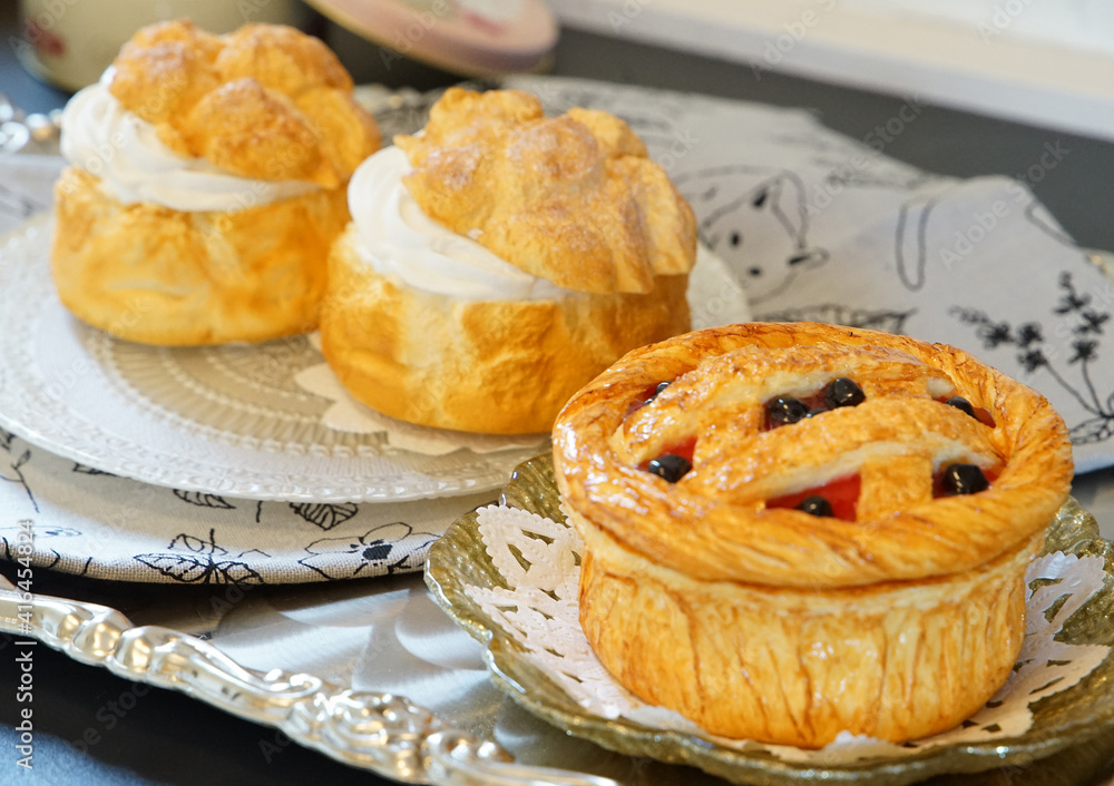 Time for dessert of pies and cream puffs on the table Time for dessert of pies and cream puffs on the table