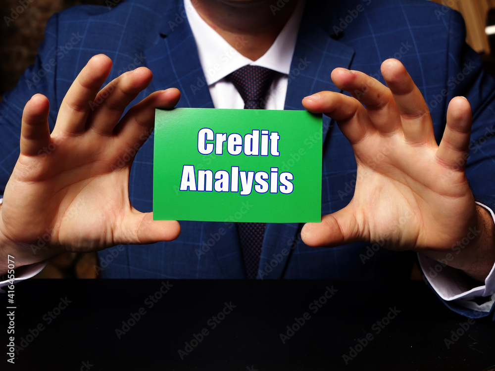 Blank green business card in a hand with phrase Credit Analysis . Horizontal shot. Blank green business card in a hand with phrase Credit Analysis . Horizontal shot.
