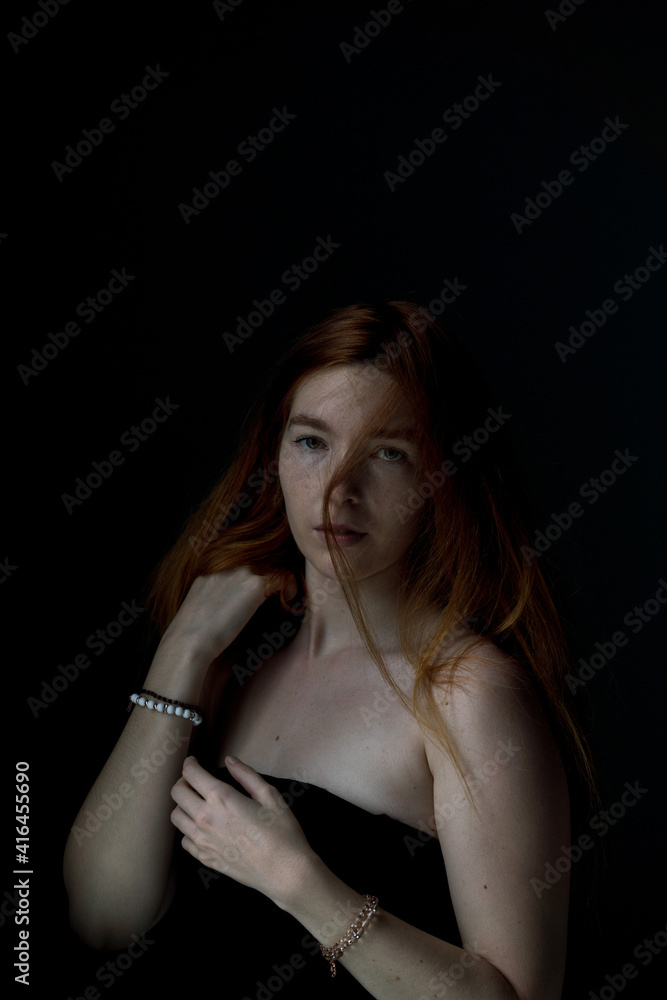 Face Close up of Ginger hair young white woman with black background Face Close up of Ginger hair young white woman with black background
