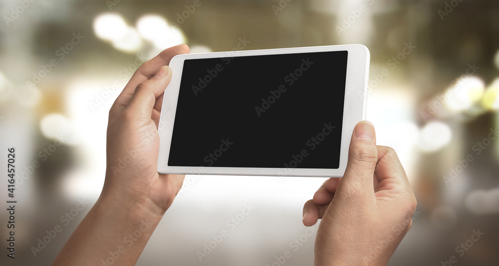 Hands holding a tablet touch computer gadget